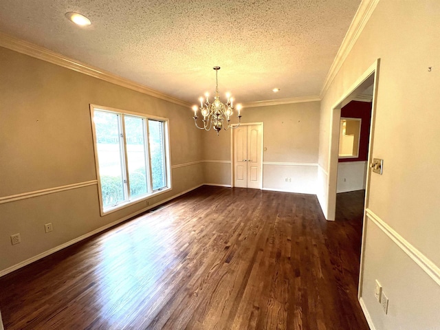 spare room with dark wood finished floors, crown molding, and a textured ceiling