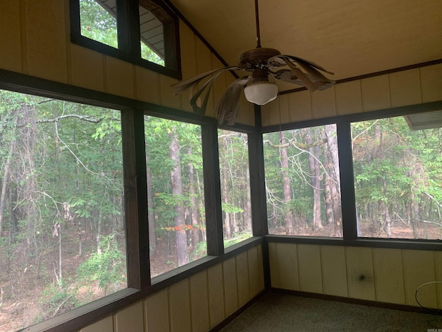 unfurnished sunroom featuring a ceiling fan