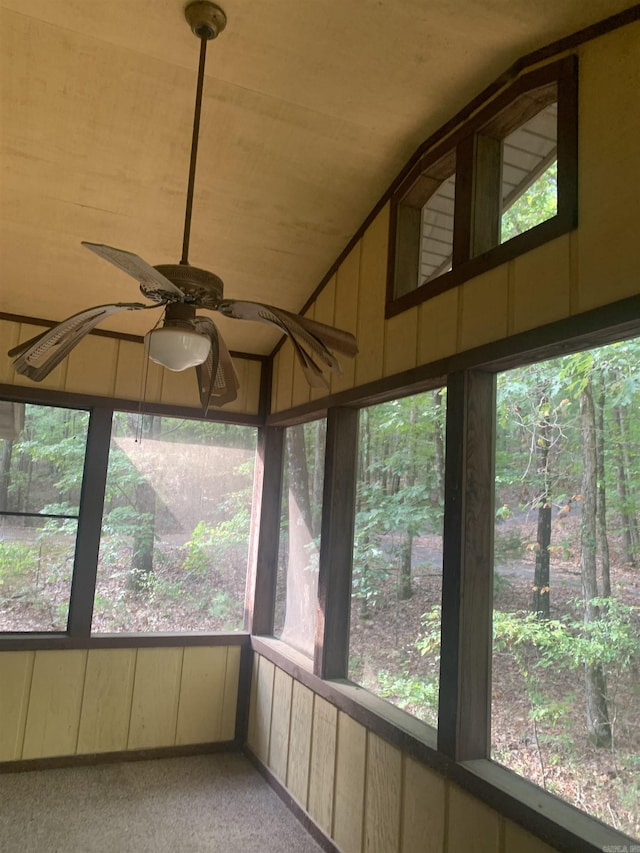 unfurnished sunroom with a ceiling fan