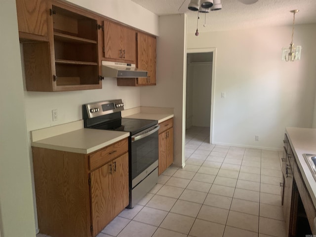 kitchen with stainless steel range with electric stovetop, brown cabinetry, light countertops, and under cabinet range hood