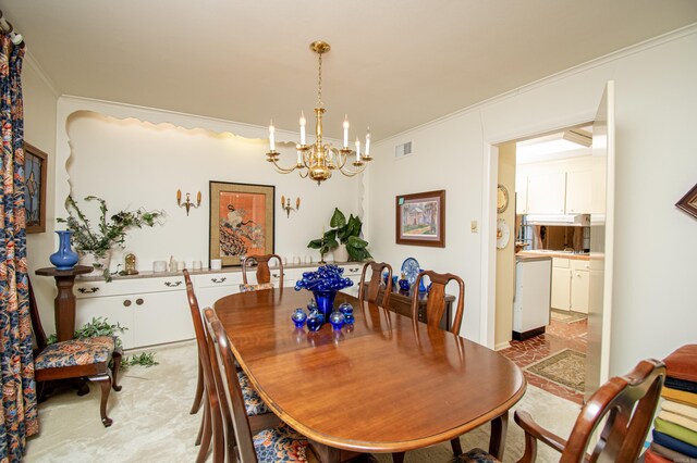 dining room featuring an inviting chandelier, visible vents, and crown molding