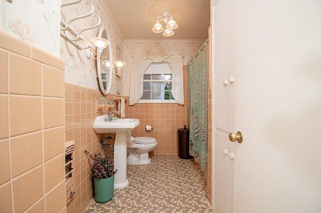 bathroom featuring toilet, wallpapered walls, ornamental molding, and tile walls