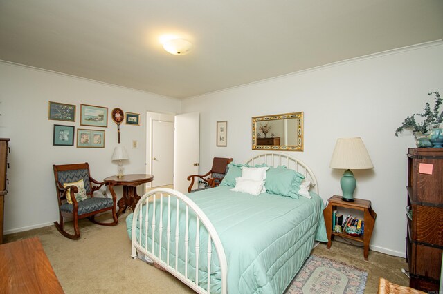 bedroom featuring crown molding and carpet