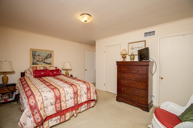 bedroom with light colored carpet and ornamental molding