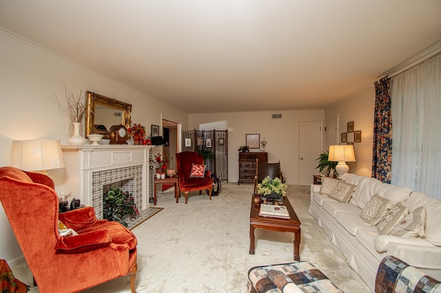 living room with a tiled fireplace and carpet flooring