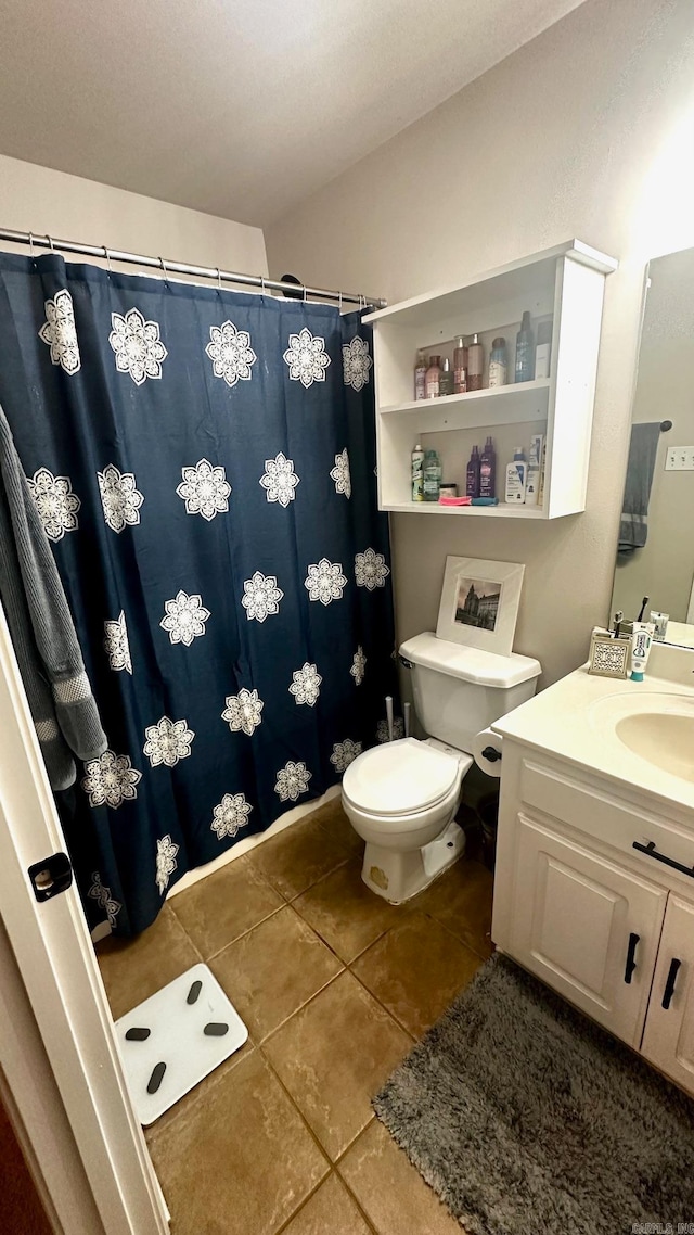 bathroom featuring vanity, toilet, curtained shower, and tile patterned flooring