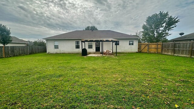 back of house with a lawn and a patio area