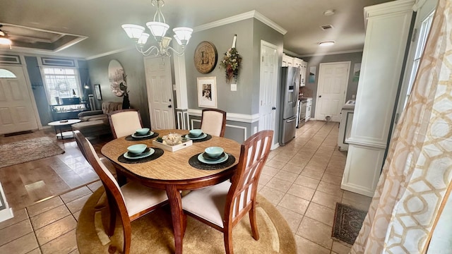 dining room featuring light tile patterned floors, an inviting chandelier, and ornamental molding