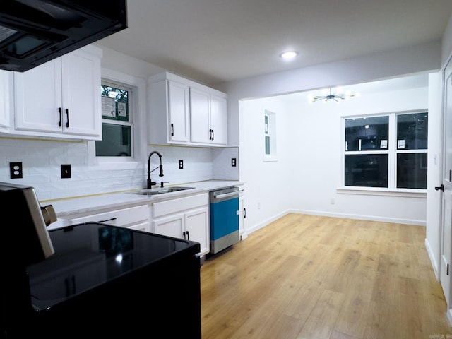 kitchen with white cabinets, light hardwood / wood-style floors, sink, exhaust hood, and stainless steel dishwasher