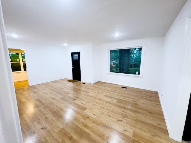 empty room with light hardwood / wood-style flooring