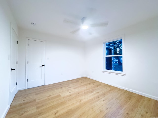 unfurnished room featuring hardwood / wood-style floors and ceiling fan