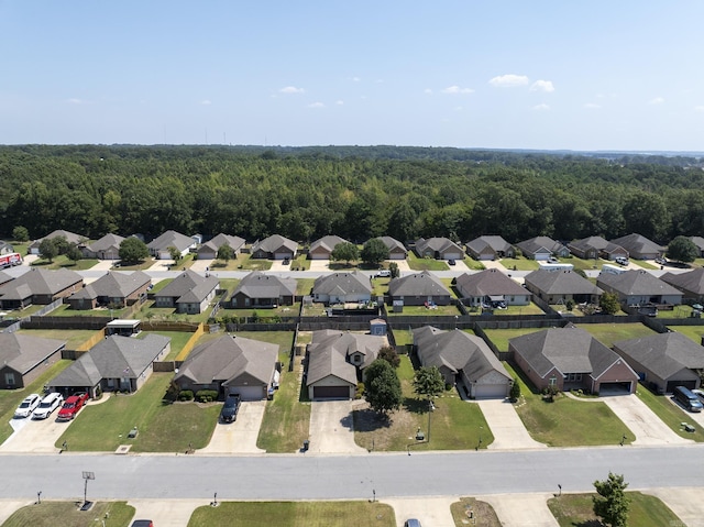 drone / aerial view with a forest view and a residential view