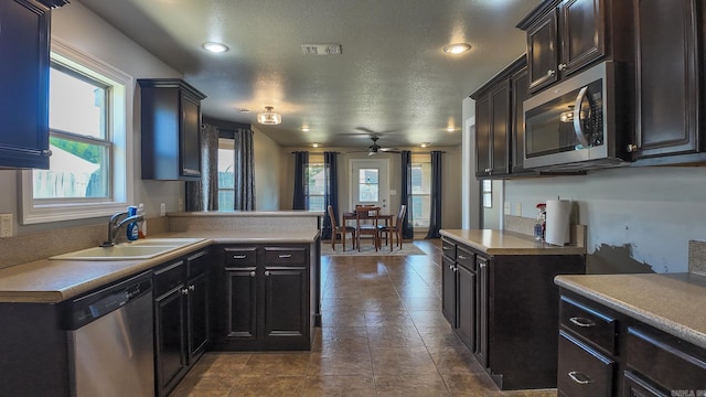 kitchen with stainless steel appliances, plenty of natural light, visible vents, and a sink