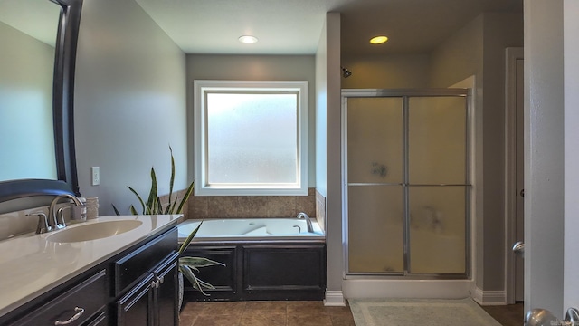 bathroom featuring a stall shower, tile patterned flooring, vanity, and a bath