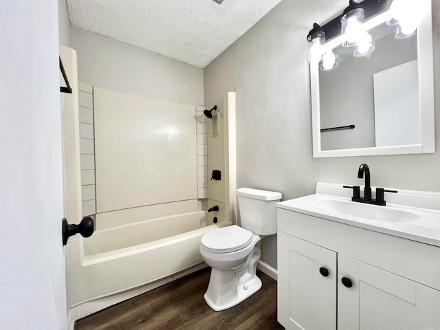 full bathroom with hardwood / wood-style floors, toilet, bathing tub / shower combination, vanity, and a textured ceiling