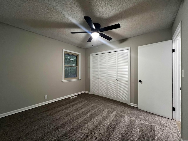 unfurnished bedroom featuring a textured ceiling, ceiling fan, a closet, and carpet floors