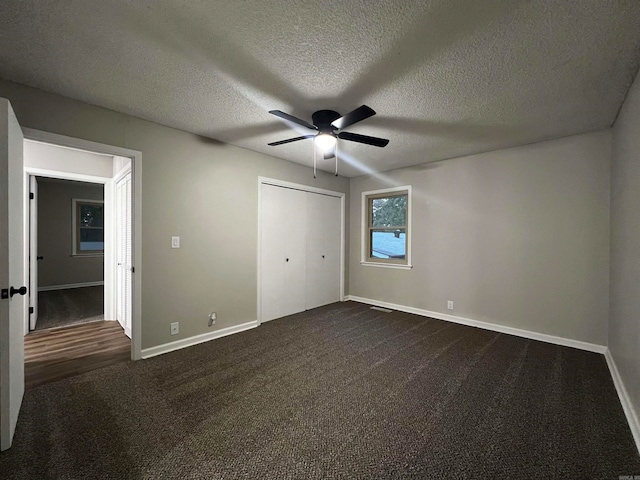 unfurnished bedroom with a textured ceiling, ceiling fan, a closet, and carpet floors