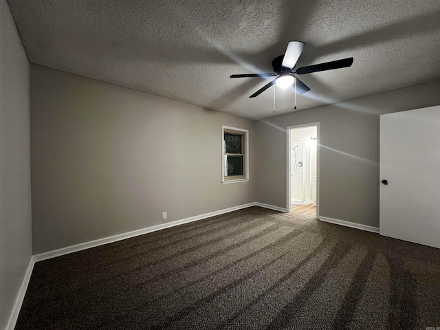 carpeted spare room featuring ceiling fan and a textured ceiling