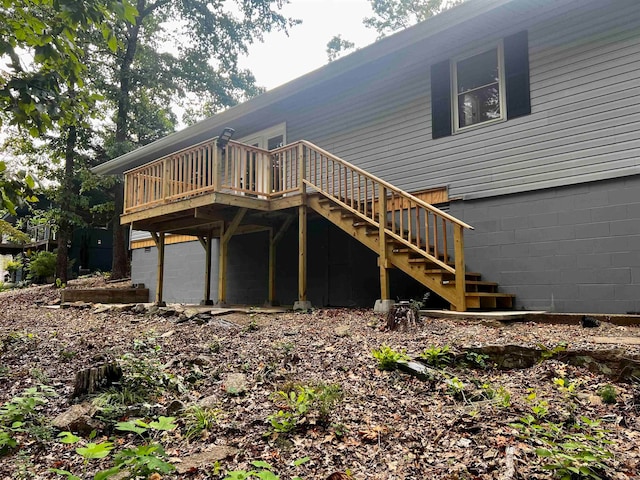 back of house featuring a wooden deck and a garage