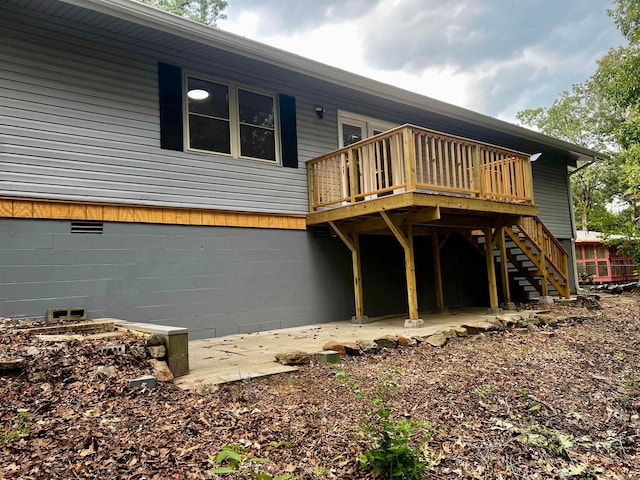 back of house featuring a deck