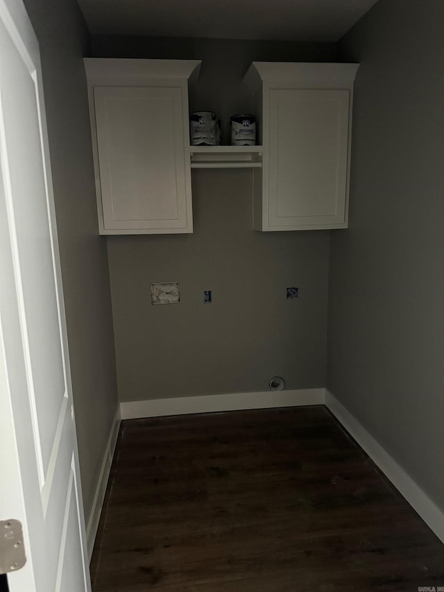 laundry area with dark wood-type flooring