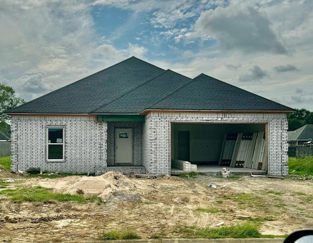 rear view of house with a garage