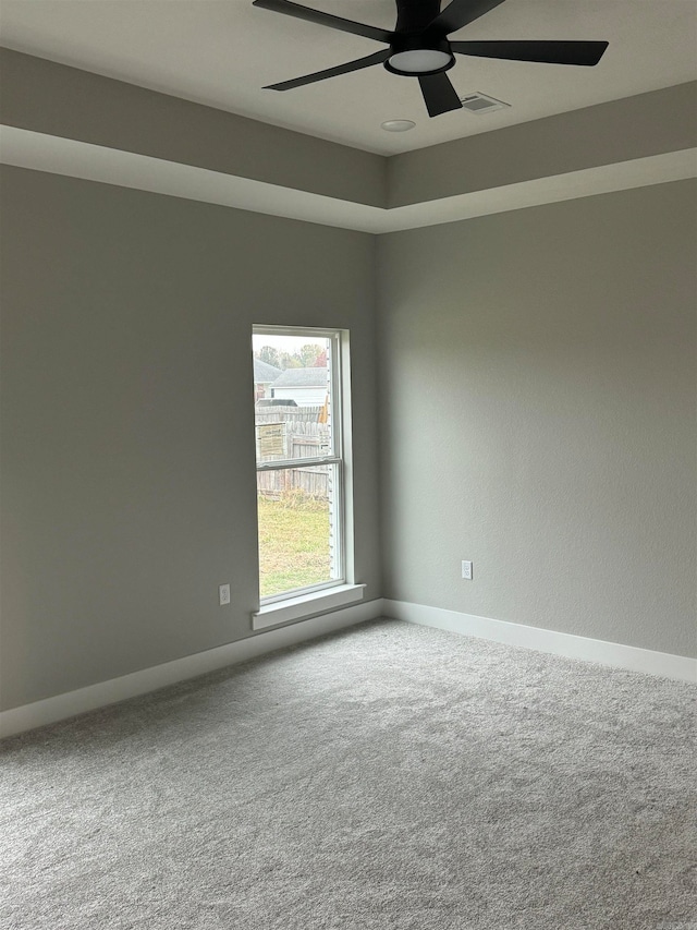 empty room with ceiling fan and carpet floors