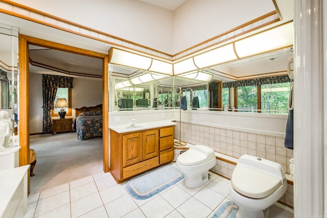 bathroom featuring tile patterned flooring, toilet, and vanity