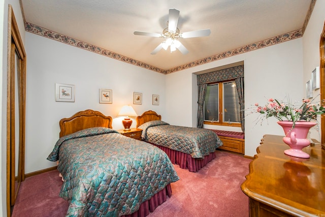 bedroom featuring a closet, ceiling fan, carpet, and a textured ceiling