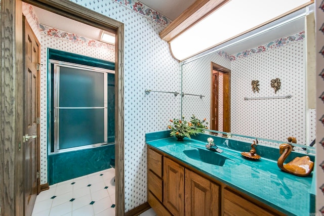 full bathroom with vanity, toilet, and bath / shower combo with glass door