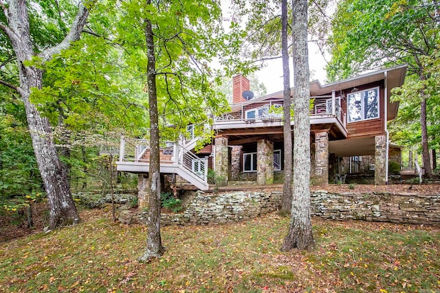 rear view of property featuring a deck