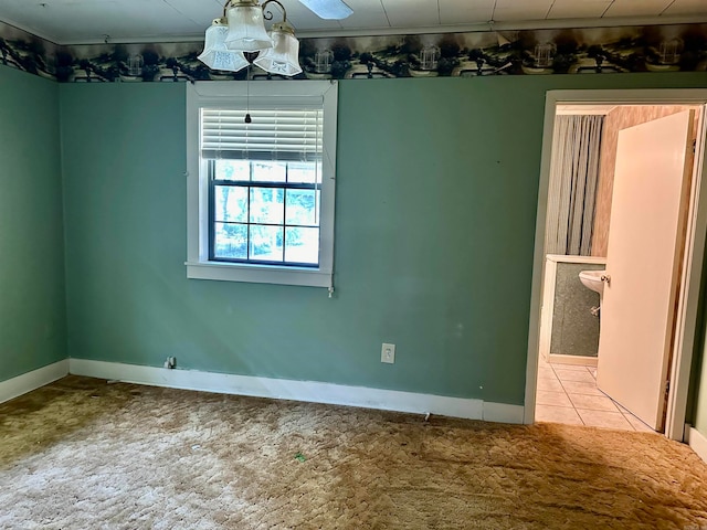 carpeted spare room featuring ceiling fan