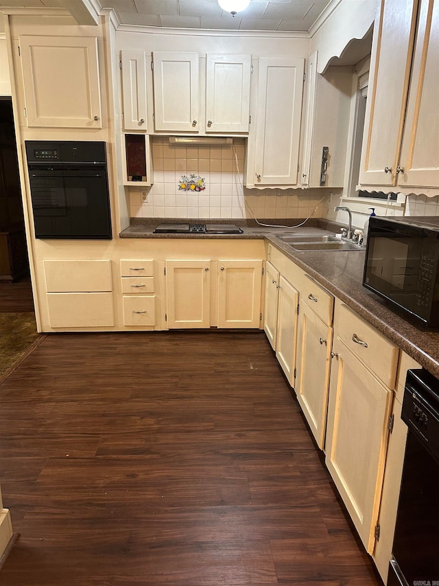 kitchen with black appliances, sink, dark hardwood / wood-style flooring, and tasteful backsplash