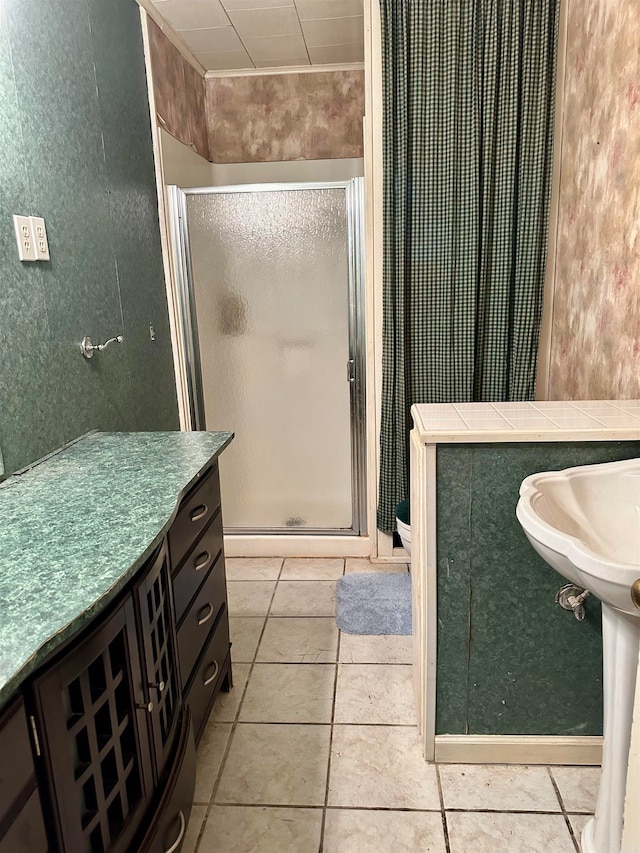 bathroom with toilet, tile patterned floors, and a shower with door