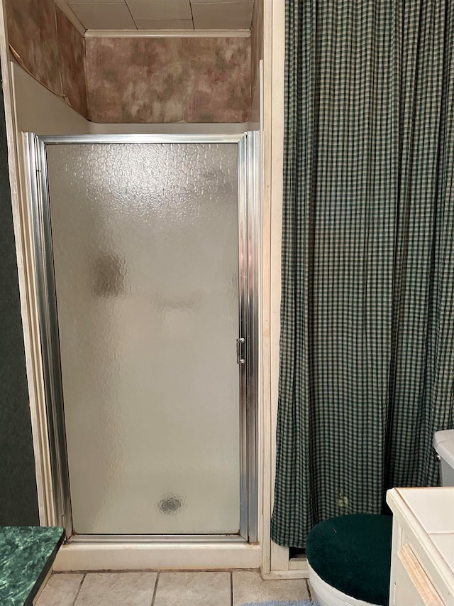 bathroom with a shower with door, vanity, and toilet