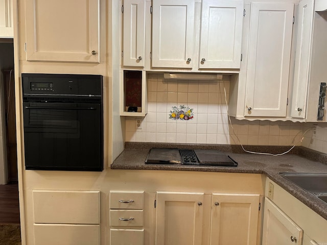 kitchen featuring black appliances and decorative backsplash