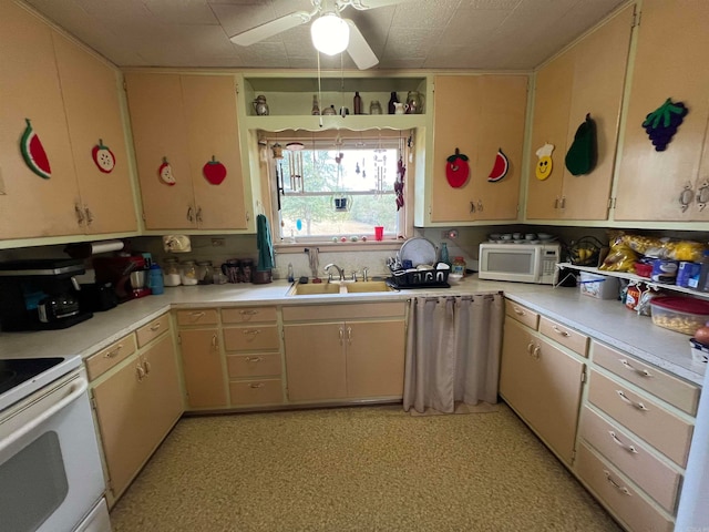 kitchen featuring cream cabinets, ceiling fan, sink, and white appliances