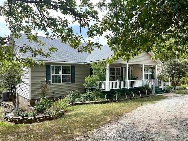 view of front facade with central AC and covered porch