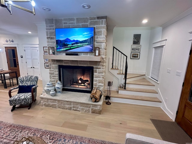 living room with wood-type flooring and a fireplace