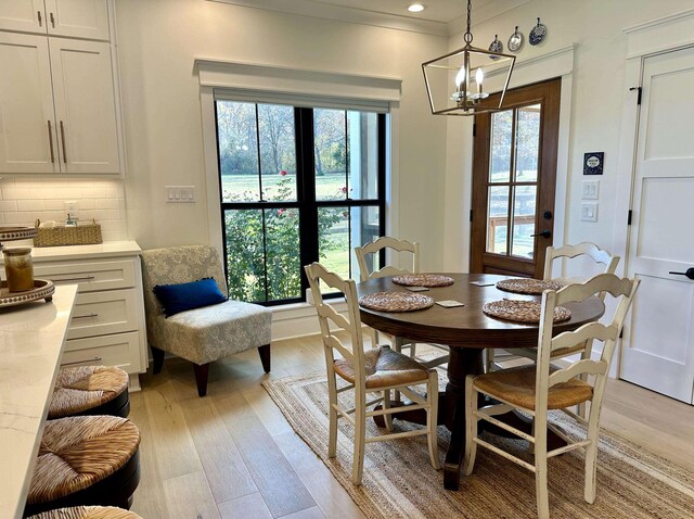 kitchen featuring visible vents, a kitchen island, a breakfast bar, stainless steel appliances, and white cabinets