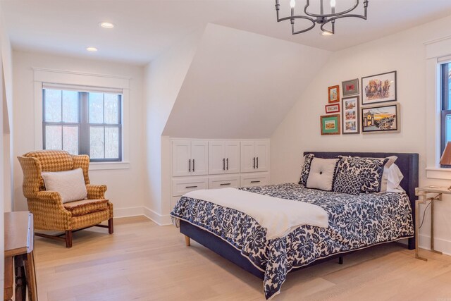 bedroom with light wood finished floors, baseboards, lofted ceiling, recessed lighting, and a notable chandelier