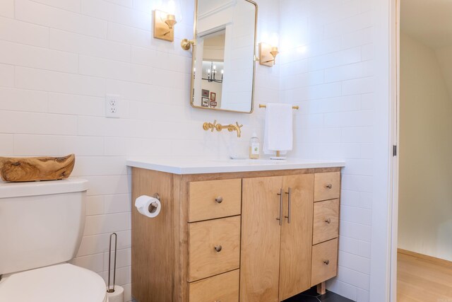 bathroom featuring vanity, toilet, and hardwood / wood-style floors