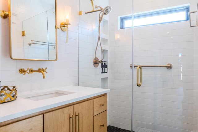 bathroom featuring vanity, tile walls, and walk in shower