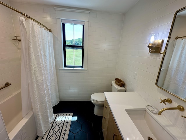 bathroom featuring toilet, vanity, shower / tub combo, tile patterned floors, and tile walls