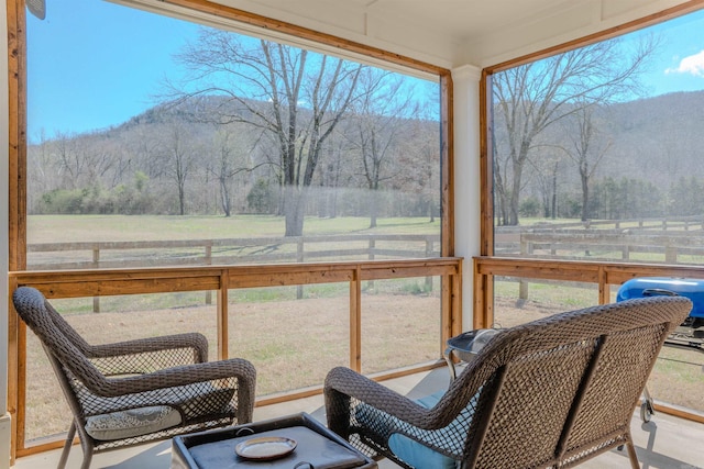 sunroom featuring a rural view