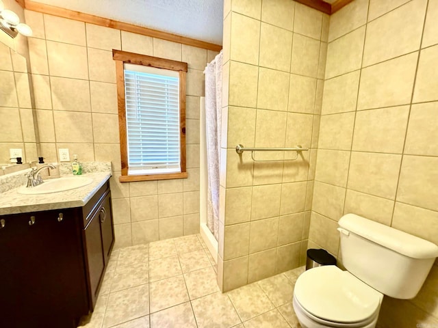 bathroom featuring toilet, vanity, a textured ceiling, tile walls, and a shower with shower curtain