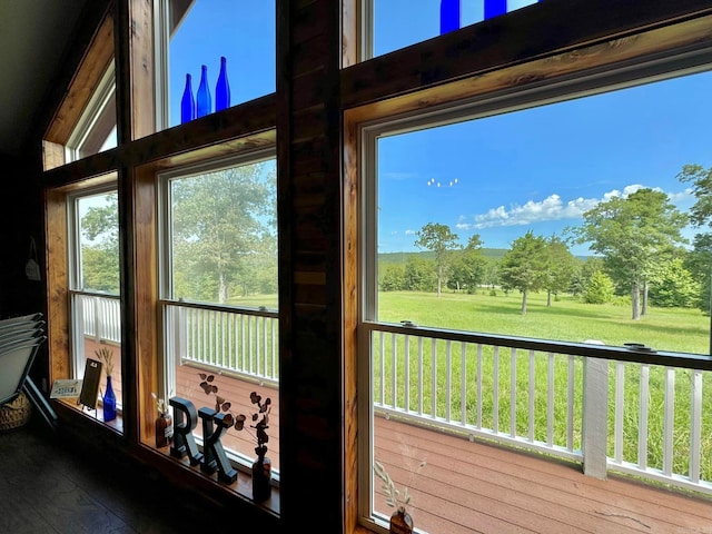 sunroom featuring vaulted ceiling