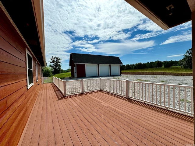 wooden deck featuring an outbuilding and a garage