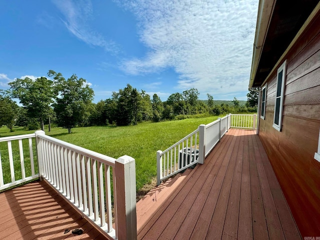 wooden terrace featuring a yard