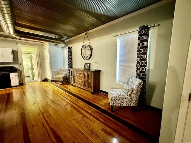 sitting room featuring baseboards and wood-type flooring